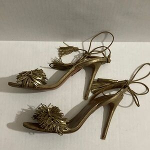 Aquazzura gold metallic strap heels.